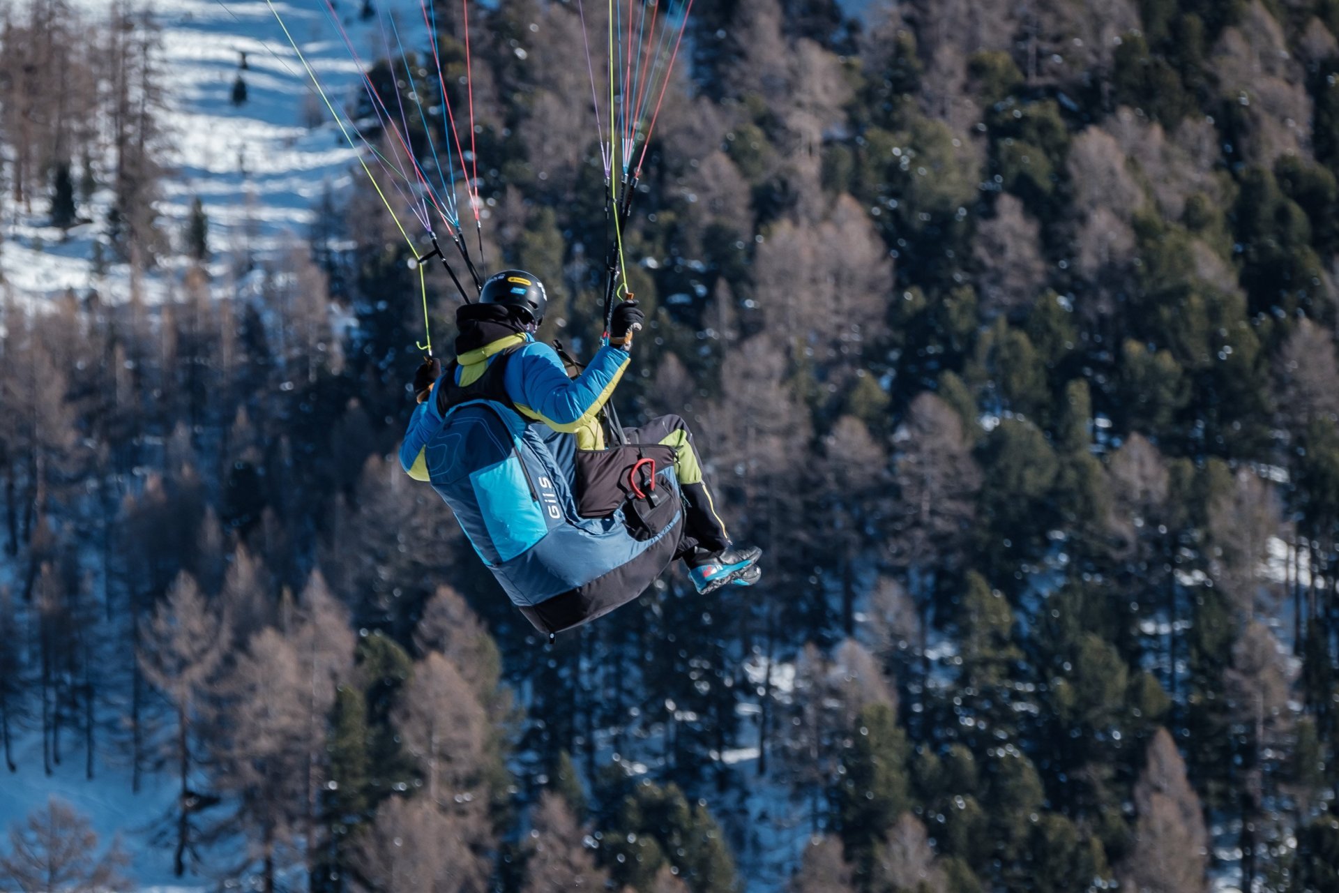 Paragliding harness setup near mountain launch area.