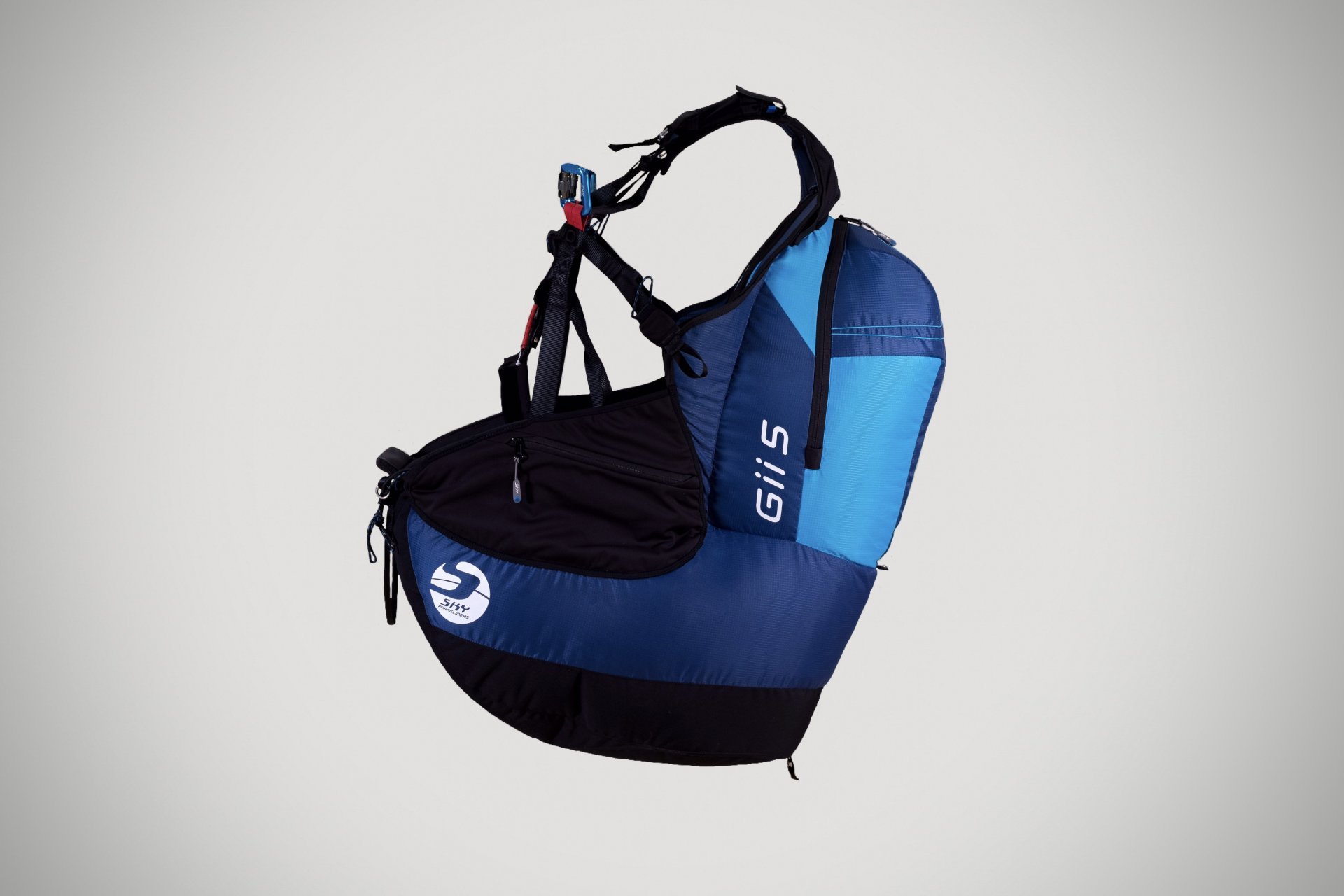 Paragliding harness setup near mountain launch area.
