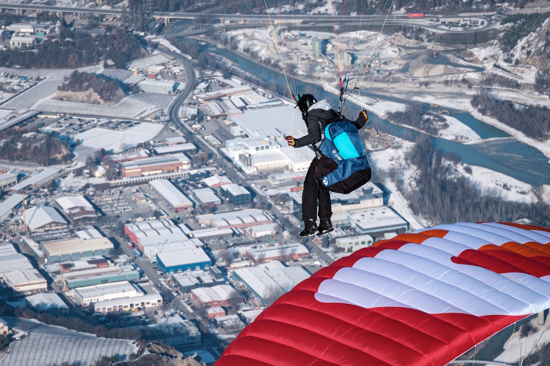 Paragliding harness setup near mountain launch area.