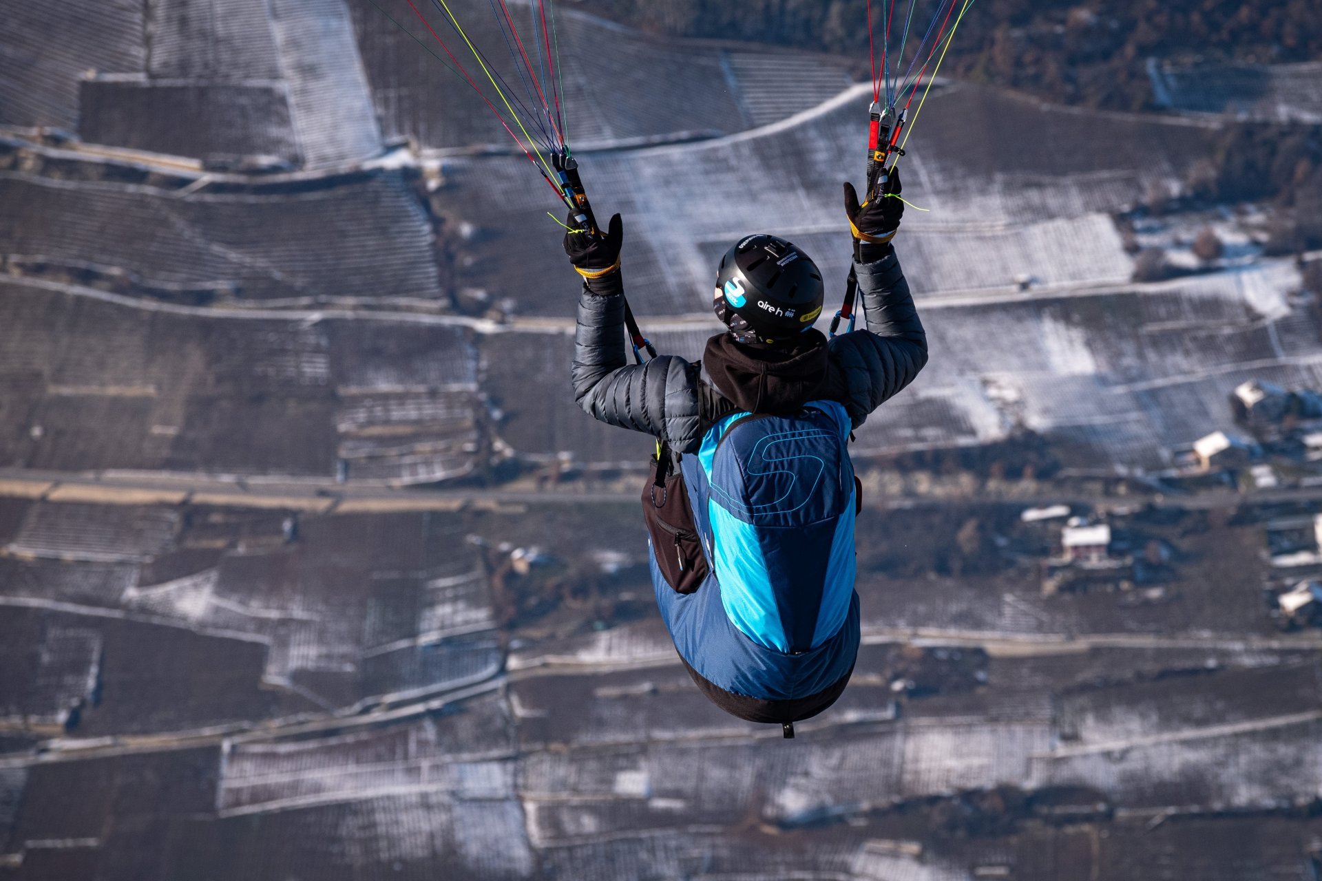 Paragliding harness setup near mountain launch area.